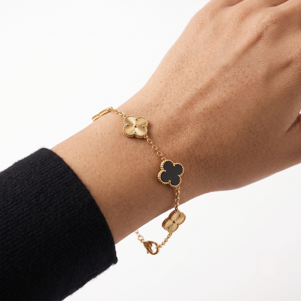 Close-up of the black & gold Lucky Clover Station Bracelet on the wrist