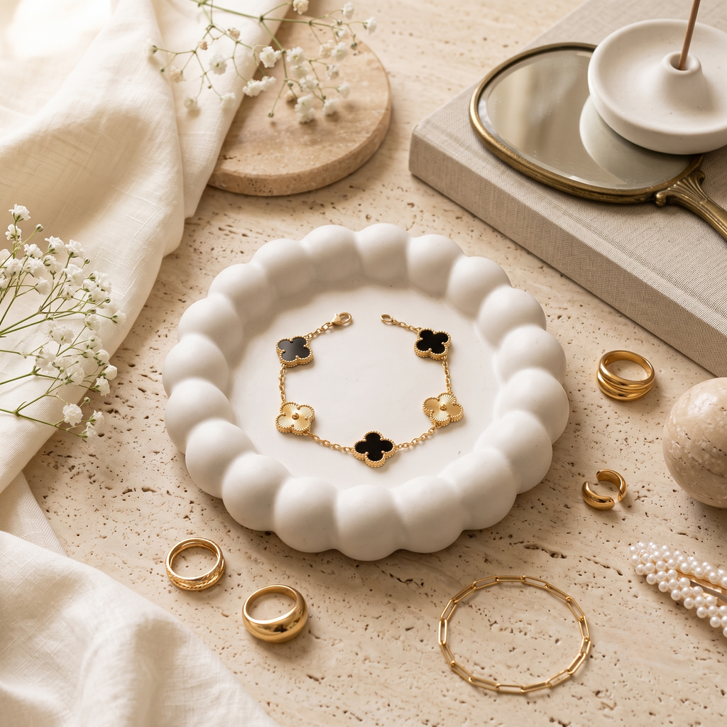 Black & gold Lucky Clover Station Bracelet, styled flat lay