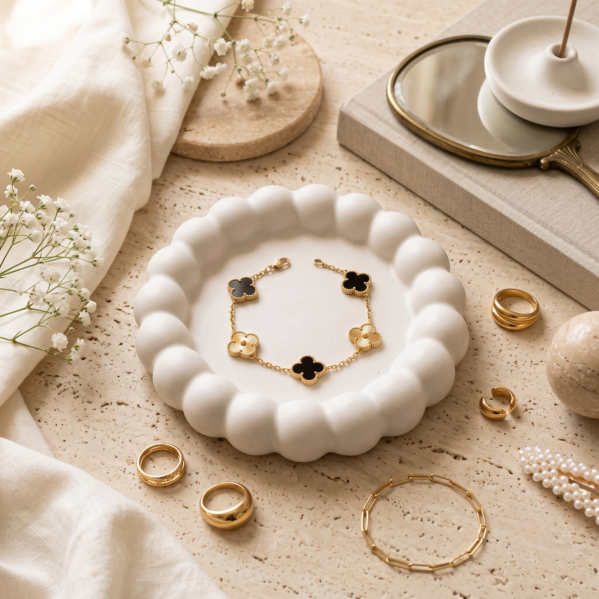 Black & gold Lucky Clover Station Bracelet, styled flat lay