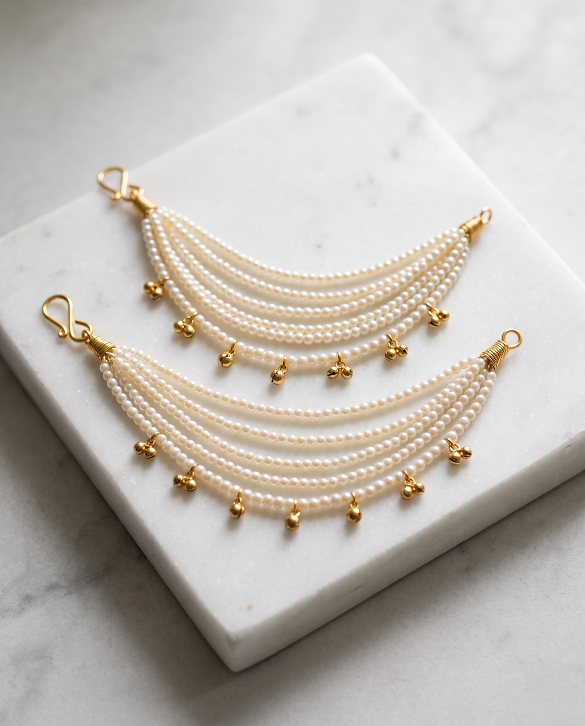 Music to My Ears pearl ear chains on marble